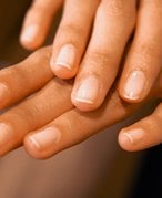 hands with nails wearing sheer nail polish