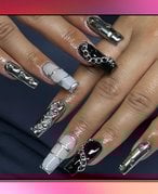 Picture of a mismatched black and silver manicure of red gradient graphic background