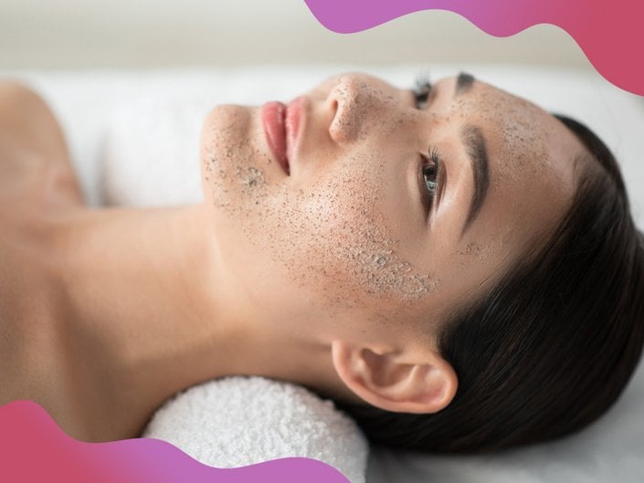 person laying on spa bed and wearing a clay mask