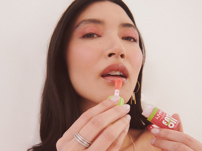 person applying glossy lip balm