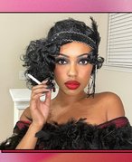 Photo of a person with dark hair wearing glam makeup and a flapper costume