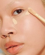 person applying concealer under their eye area