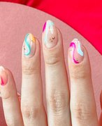 A close-up picture of a person's multicolored nail art