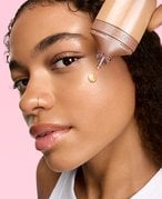 Girl applying foudation to face