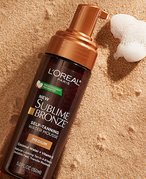 loreal paris sublime mousse tanner photographed on a sandy background
