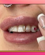 person showcasing tooth gem designs