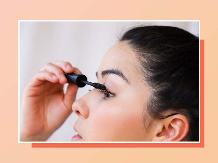 Collage with an orange background and a photo of a person with dark hair in profile, applying mascara to their eyelashes